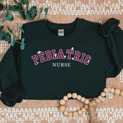 Pink- Varsity- Pediatric Nurse- Kawaii-Characters -Cozy Sweatshirt